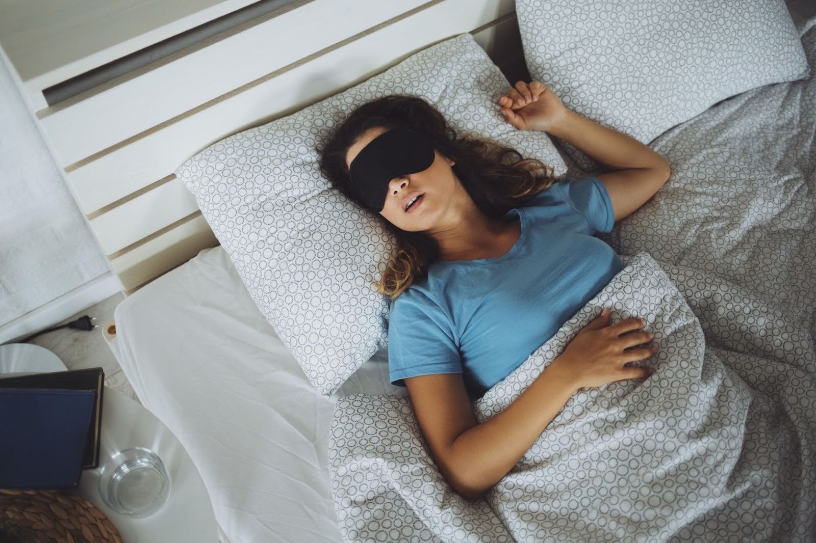A woman sound asleep wearing a black sleep mask