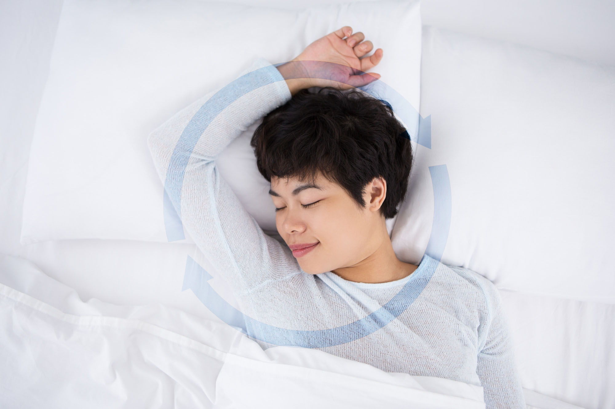 A woman smiling in her sleep, emphasizing on a peaceful sleeping experience