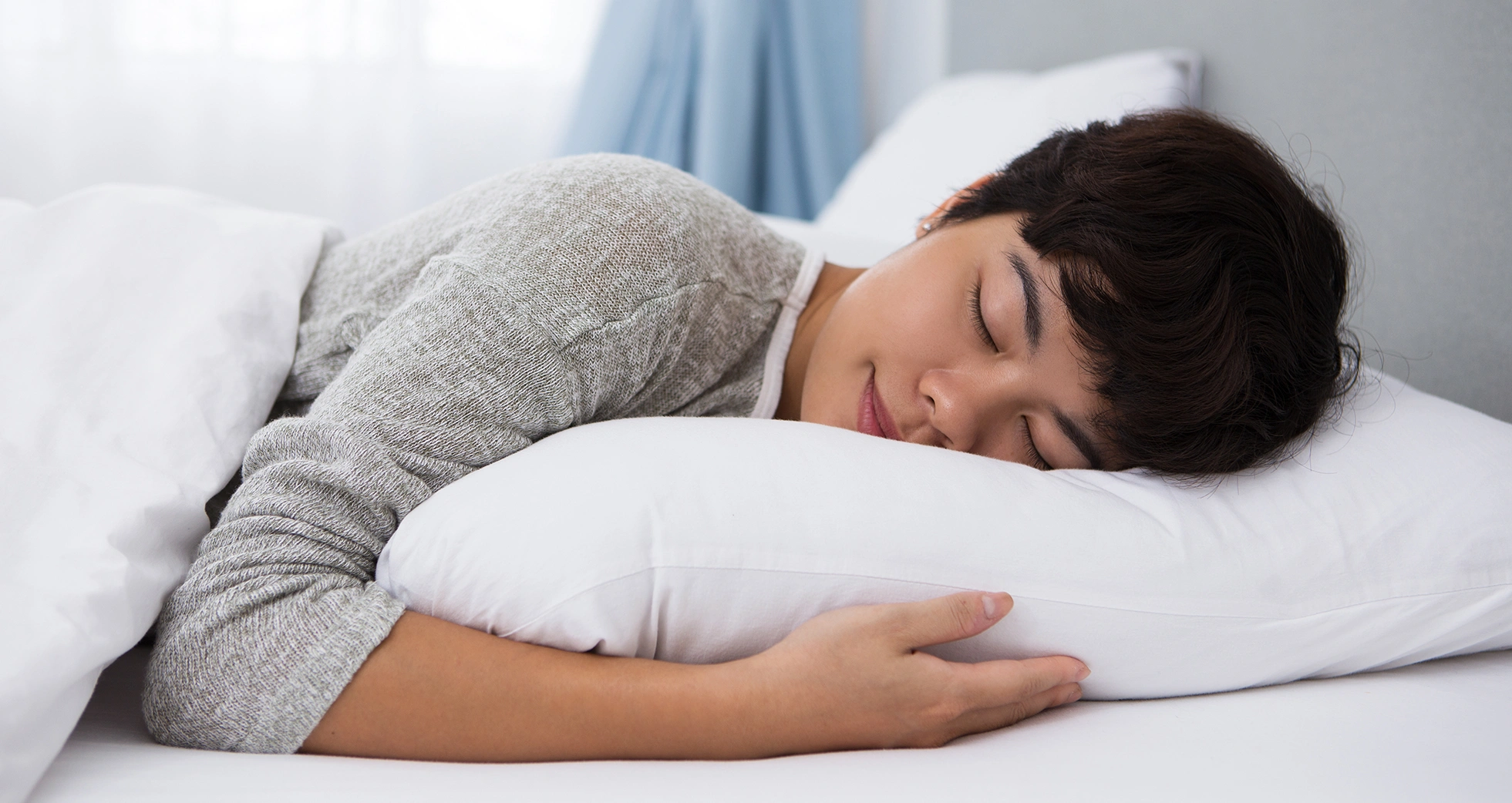 A woman sleeping peacefully with her head resting on a comfortable pillow.
