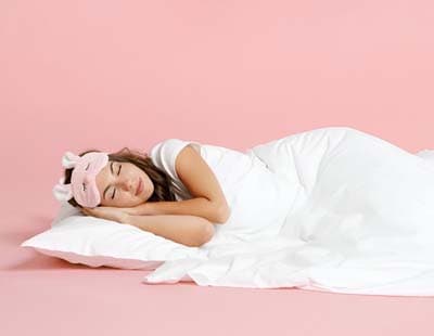 A woman sleeping in peace probably having a good dream