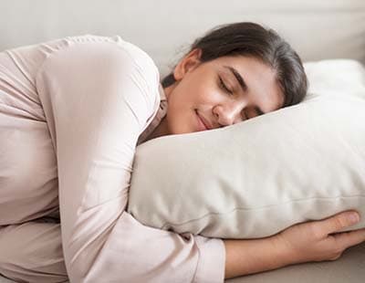 A woman sleeping comfortably on her side