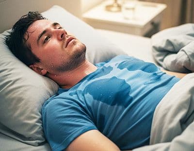 A man unable to sleep due to immense sweating.