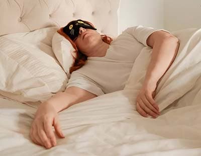Woman Wearing Eye Mask and Sleeping in an Improper Position