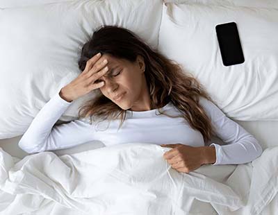 A woman unable to sleep due to stress and anxiety