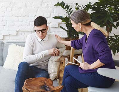 A medical expert conducting psychotherapy on a patient
