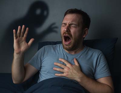 A man unable to sleep, emphasizing on night terror effects