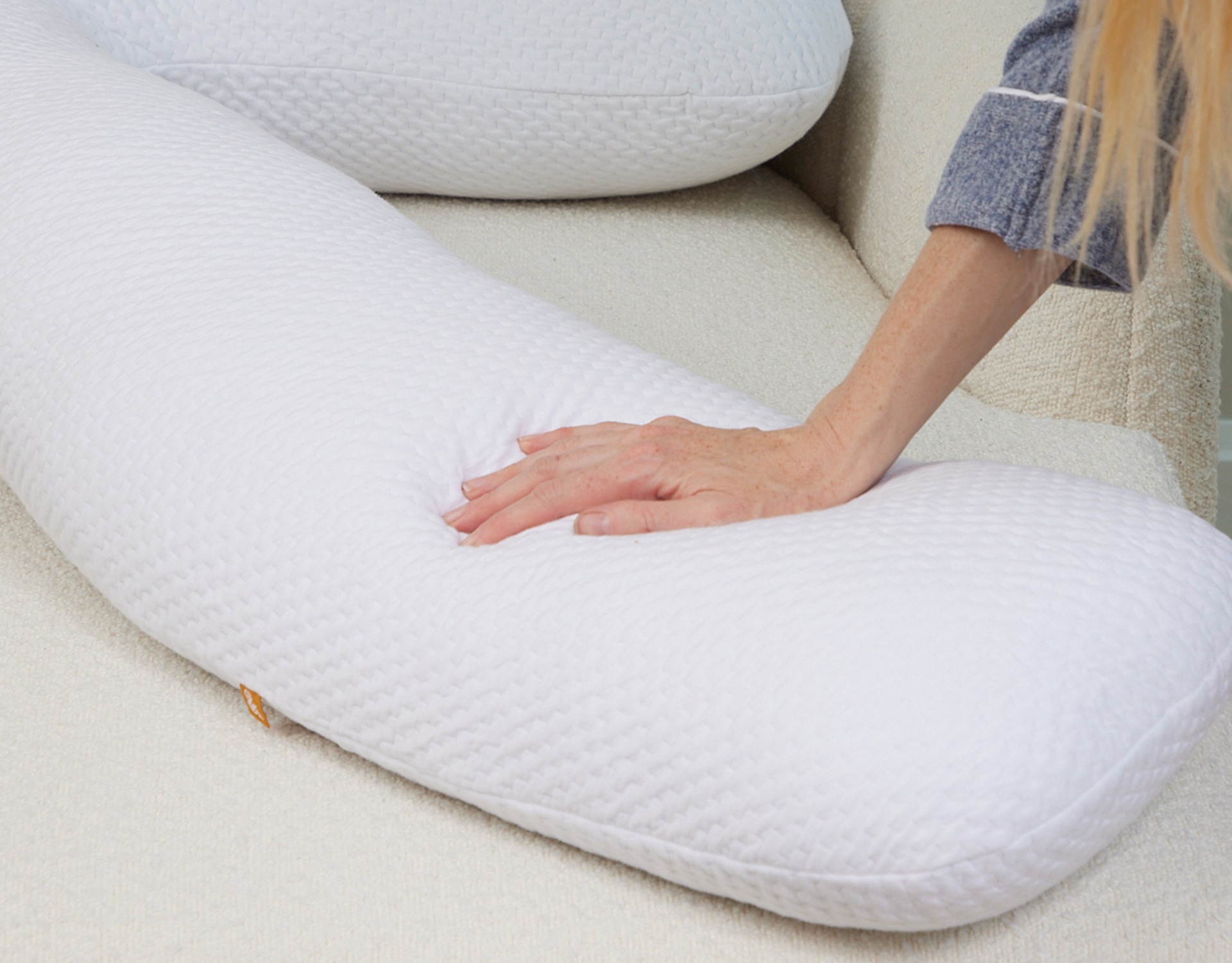 hand pressing a body pillow
