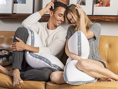 the couple on the couch holding pillows