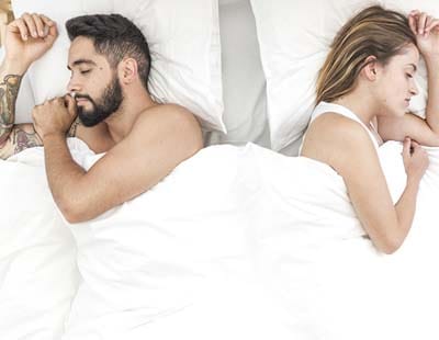 Couple sleeping on either side