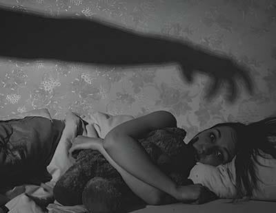 A woman unable to sleep due to scary dreams