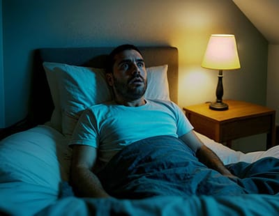 A man unable to sleep is awake with his eyes wide open.