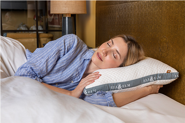 A women resting her head on Eli & Elm side sleeping pillow