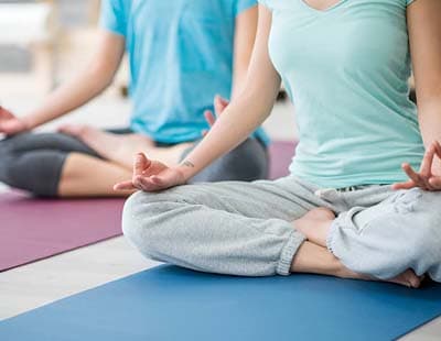 Two women sitting and meditating
