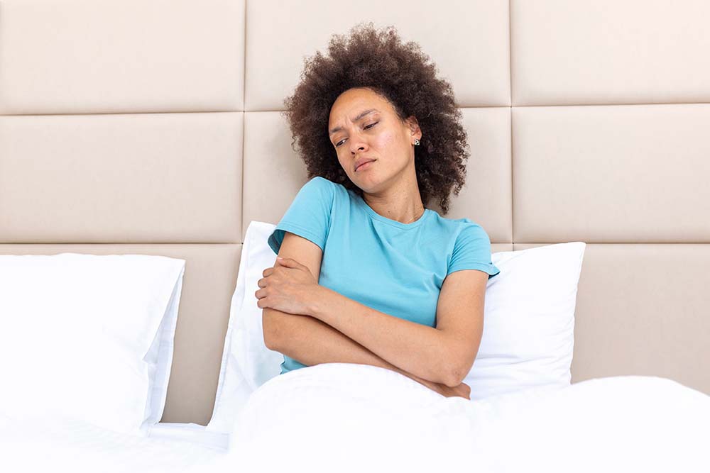 Woman lying with her arms numb after waking up