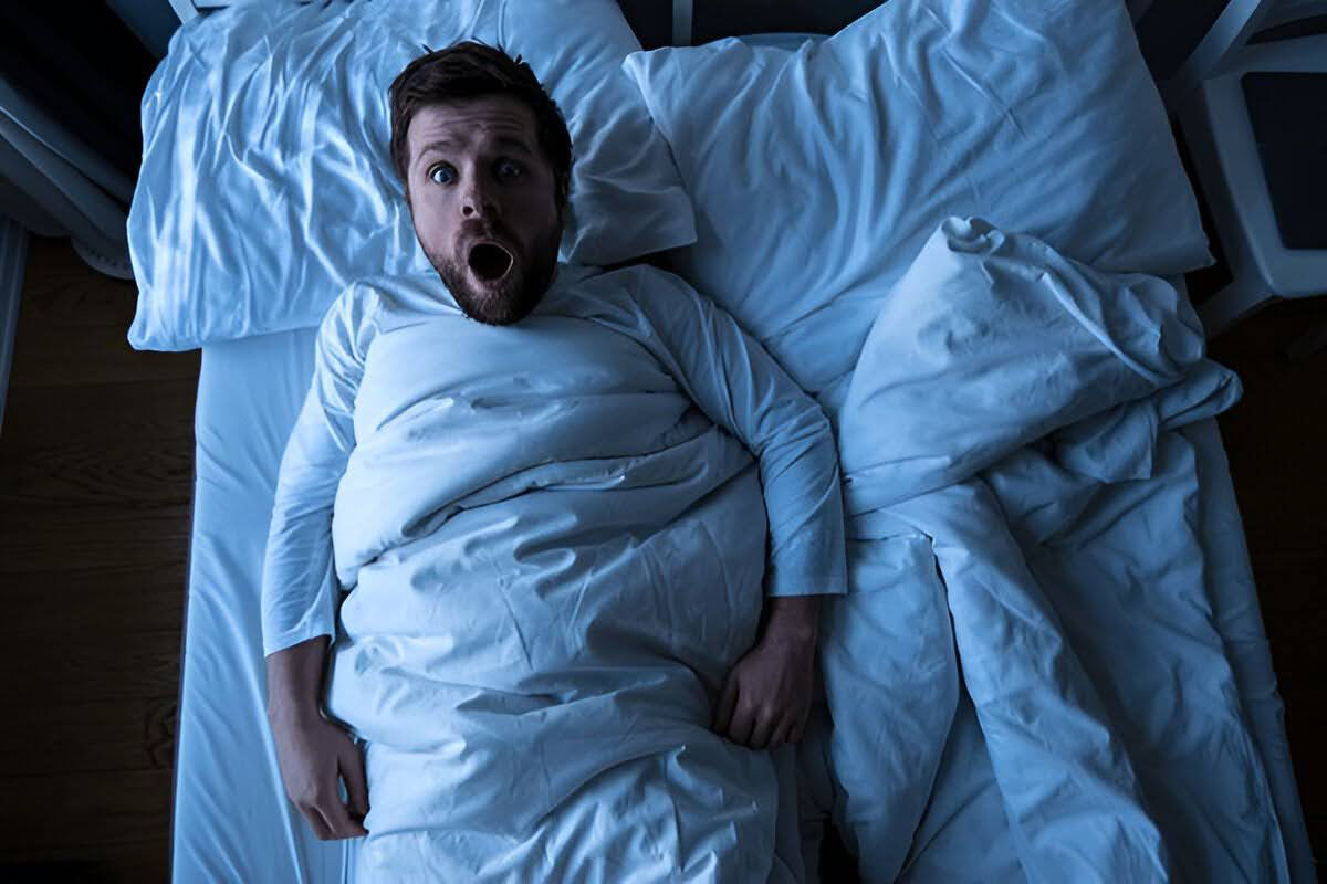 A man waking up in shock