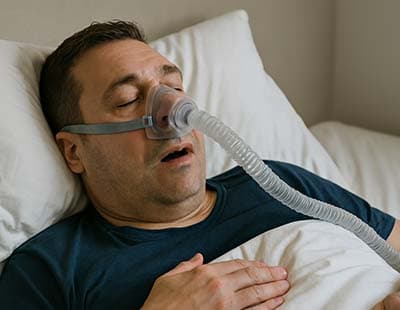 A man going through CPAP therapy to treat sleep apnea
