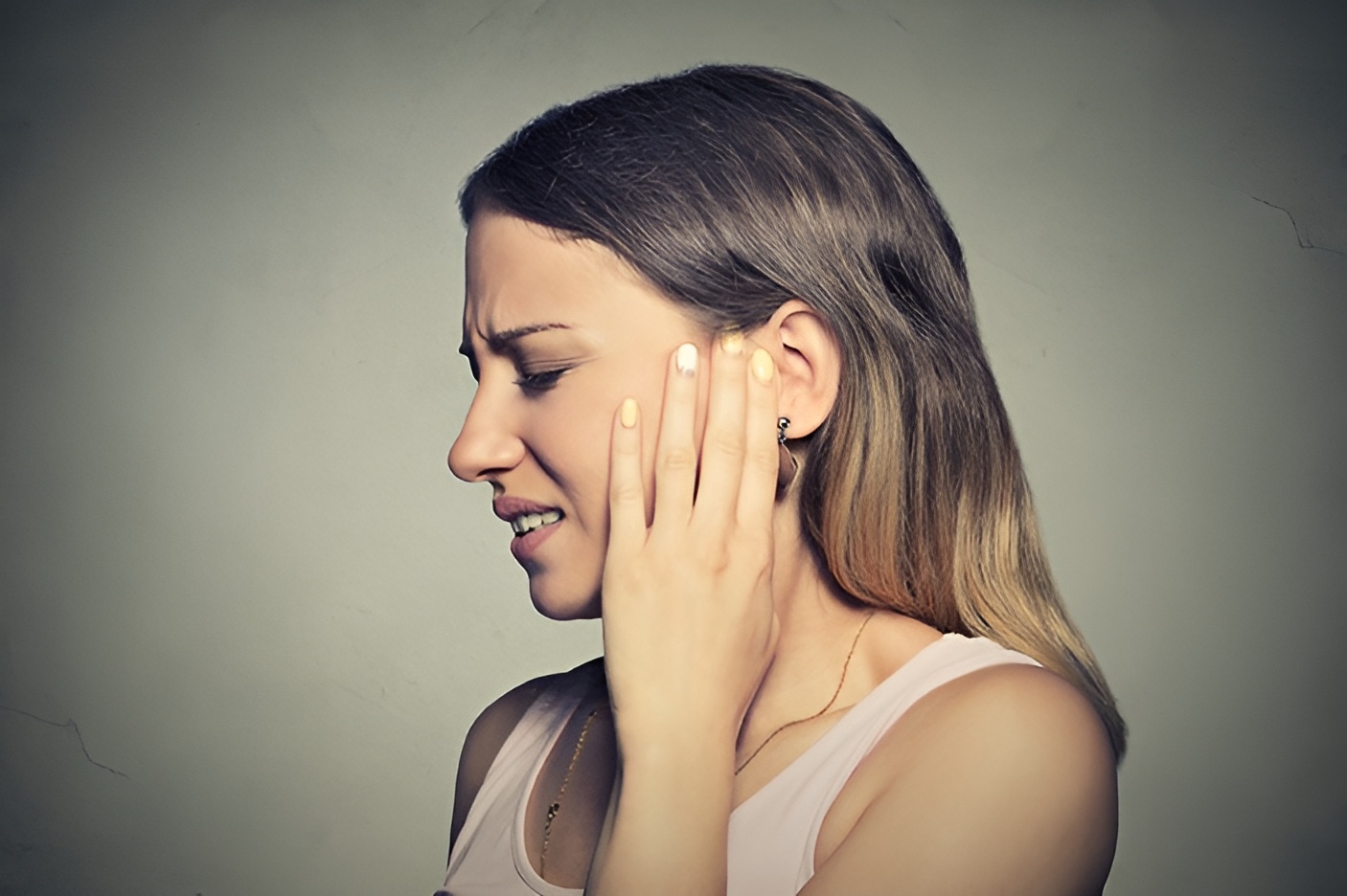 A woman suffering from some sort of ear pain