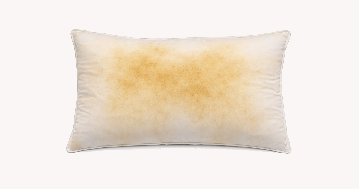A white pillow turned yellowish with stains